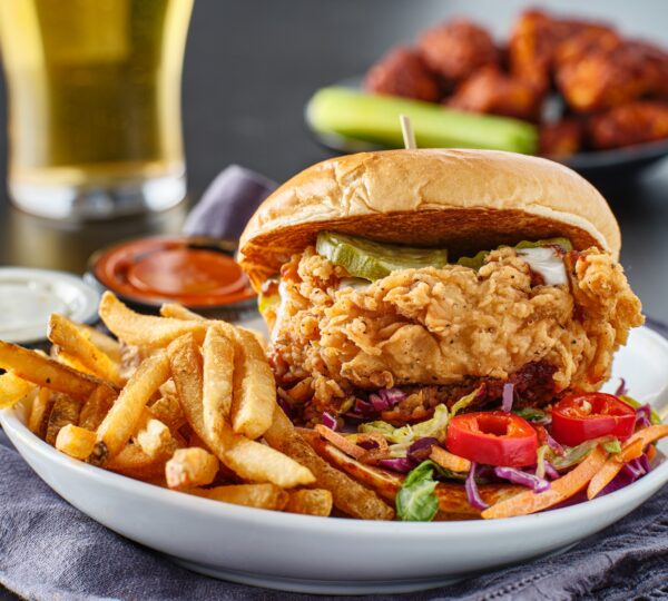 fried chicken sandwich with coleslaw and french fries